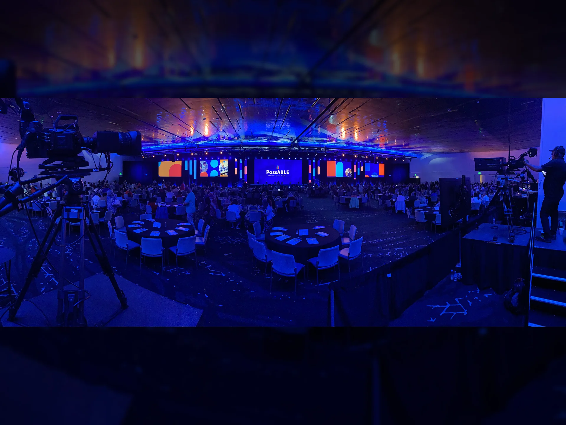 Wide view of the DDS PossABLE conference with camera platforms, LED displays, and live event production in Oklahoma City.