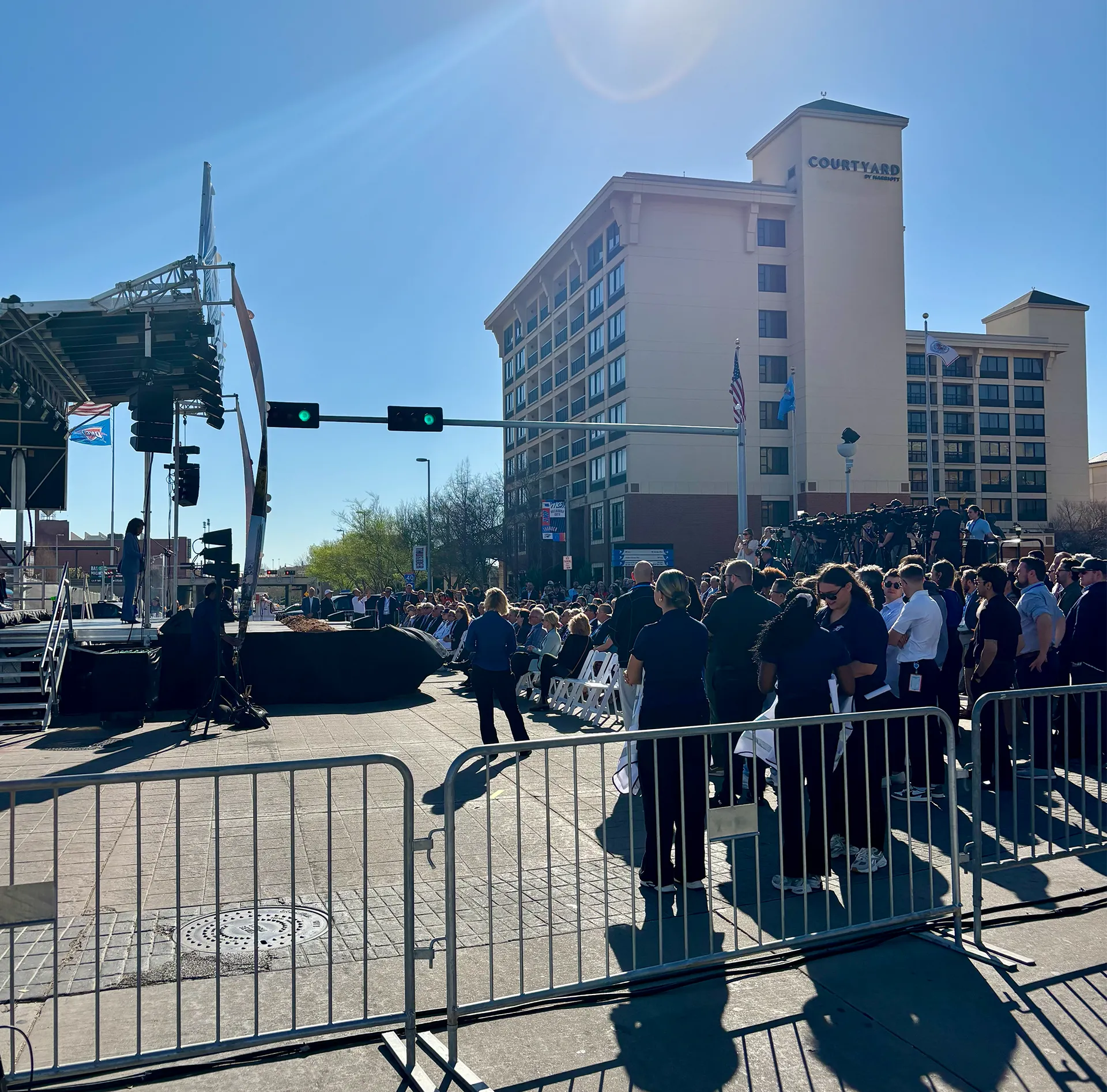 Attendees and media gathered at outdoor groundbreaking ceremony stage produced by CNS Productions in downtown Oklahoma City